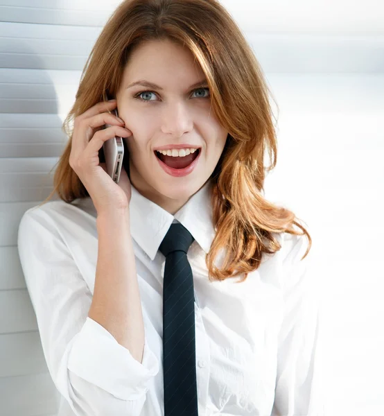 Beautiful young business woman talking on the phone