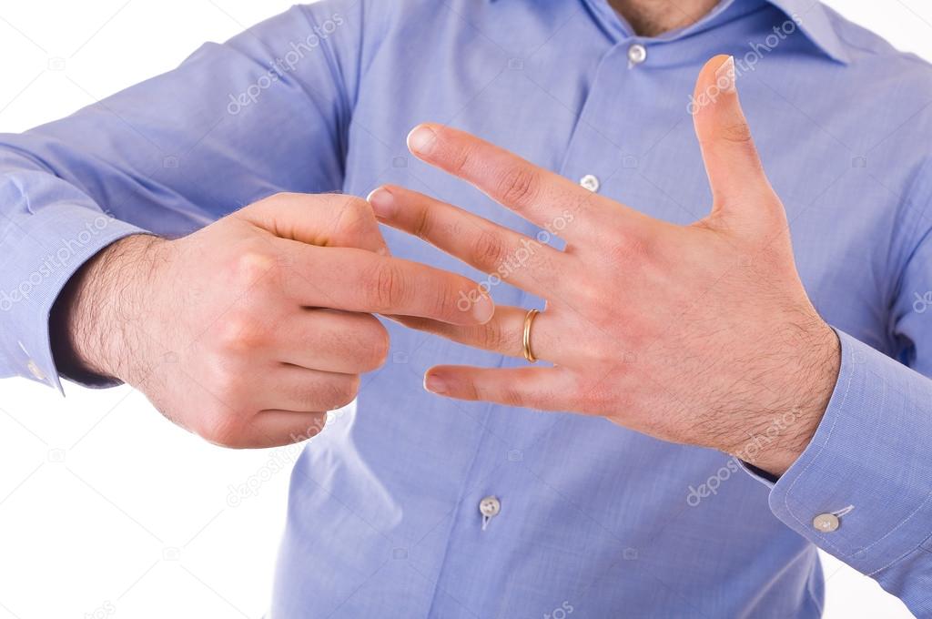 Young man indicating wedding ring.