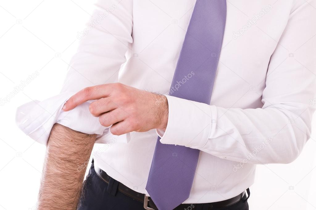 Businessman rolling up sleeves.