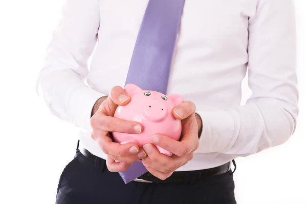 Geschäftsmann hält ein Sparschwein. — Stockfoto