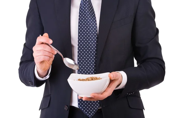 Empresario desayunando con tazón de cereal . — Foto de Stock