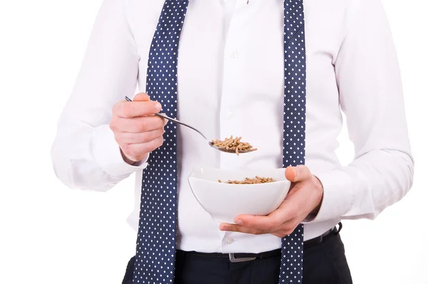 Businessman having breakfast with cereal bowl. — Stock Photo, Image