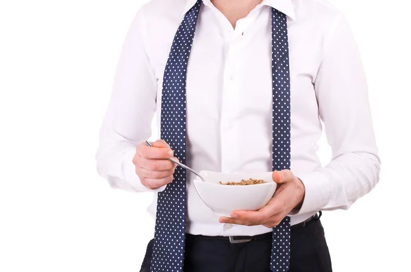 Empresário tomando café da manhã com tigela de cereais . — Fotografia de Stock