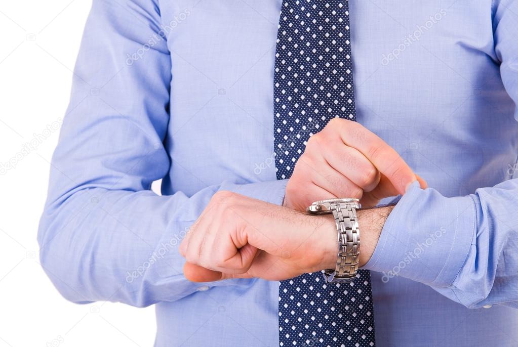 Businessman checking time on his wristwatch.