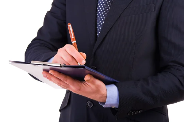 Empresario escribiendo notas en portapapeles . — Foto de Stock