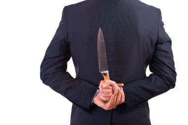 Businessman holding knife behind his back. clipart