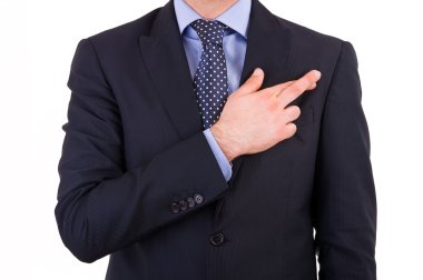 Business man with fingers crossed. clipart