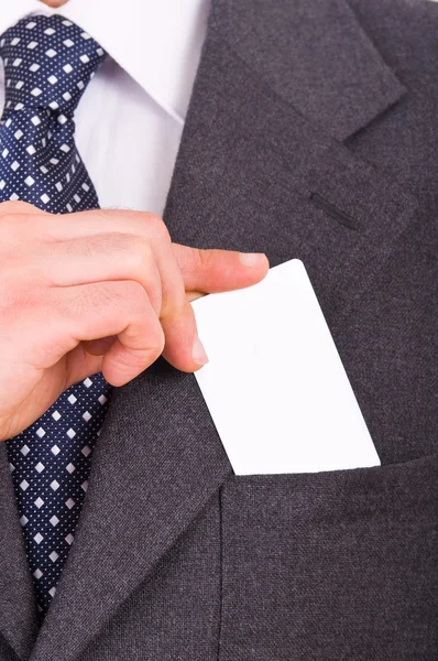 Businessman putting blank card in his pocket. — Stock Photo, Image