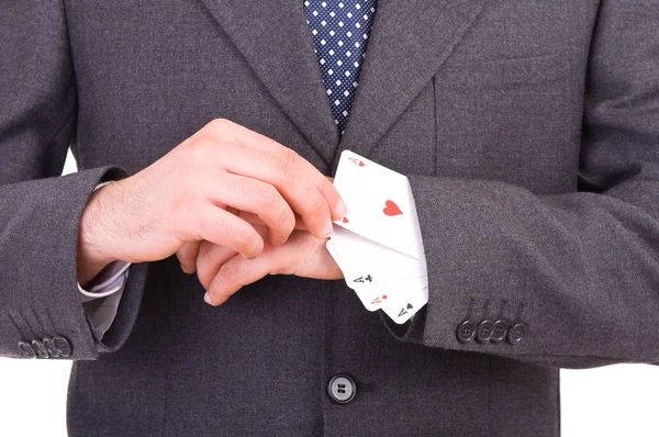 Homme d'affaires avec des cartes à jouer cachées sous la manche . — Photo