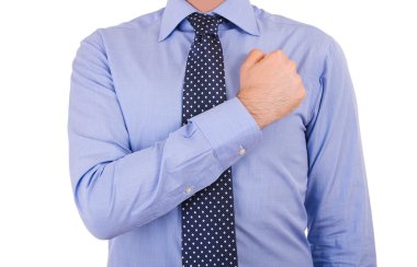 Businessman taking oath with fist over heart. clipart
