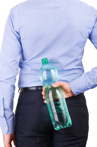 Businessman holding green bottle behind his back. — Stock Photo, Image