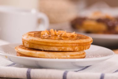 Beyaz tabakta taneli ballı krep..