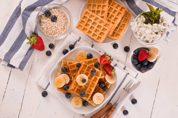 Waffles with blueberries, bananas and honey.