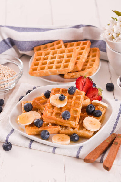 Waffles with blueberries, bananas and honey.