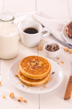 Beyaz tabakta taneli ballı krep..