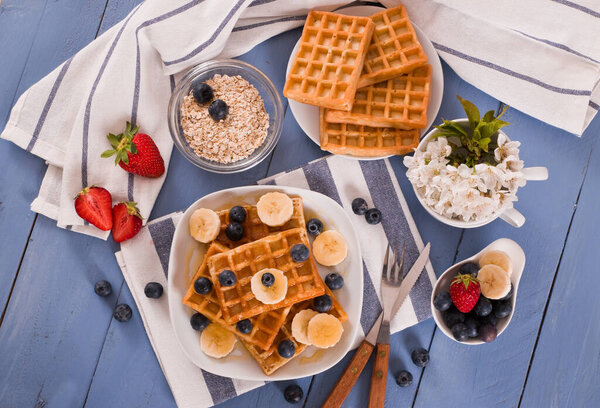Waffles with blueberries, bananas and honey.