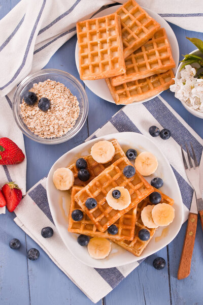 Waffles with blueberries, bananas and honey.
