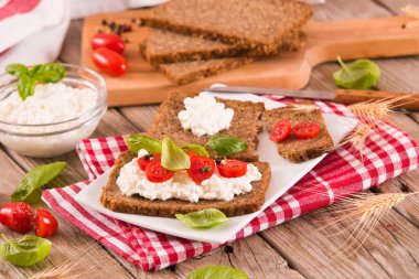 Çavdar ekmeği, süzme peynir, fesleğen ve domates..