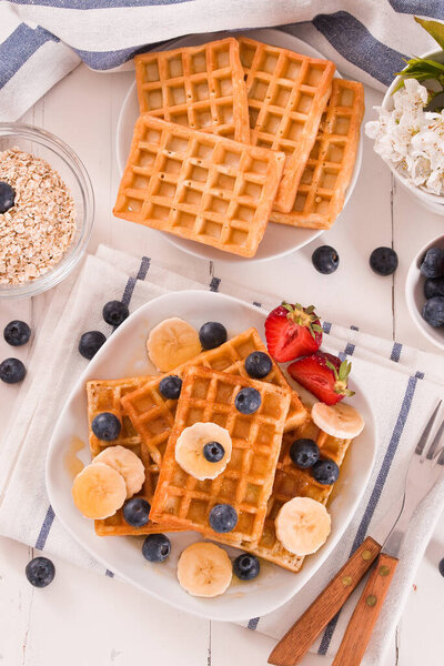 Waffles with blueberries, bananas and honey.