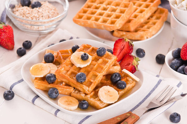 Waffles with blueberries, bananas and honey.