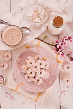 Canestrelli biscuits with icing sugar on pink dish. 