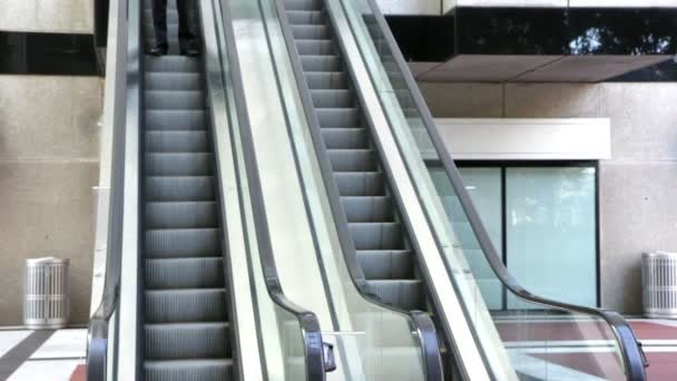 Confident businessman walking to an escalator — Stock Video