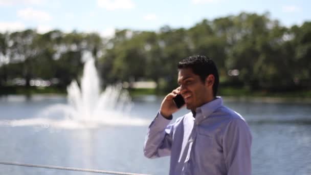 Feliz homem de negócios a falar ao telefone. caminhando — Vídeo de Stock