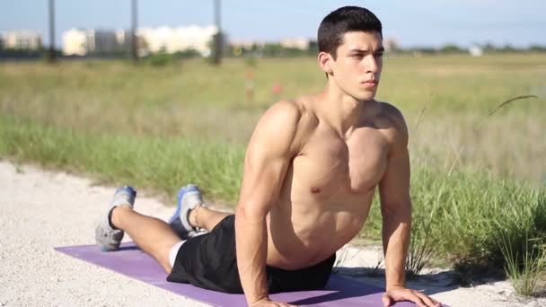Man doing yoga exercise. Cobra Pose. outdoors — Stock Video
