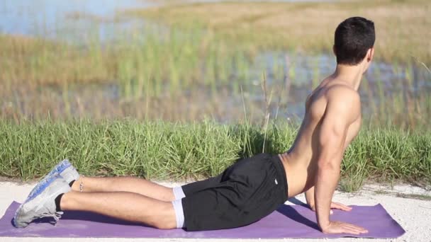 Man doing yoga exercise. Cobra Pose. outdoors — Stock Video