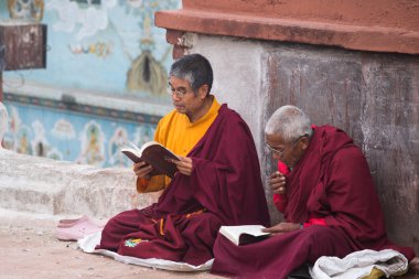 Monks praying at Bouddanath temple in Kathmandu clipart