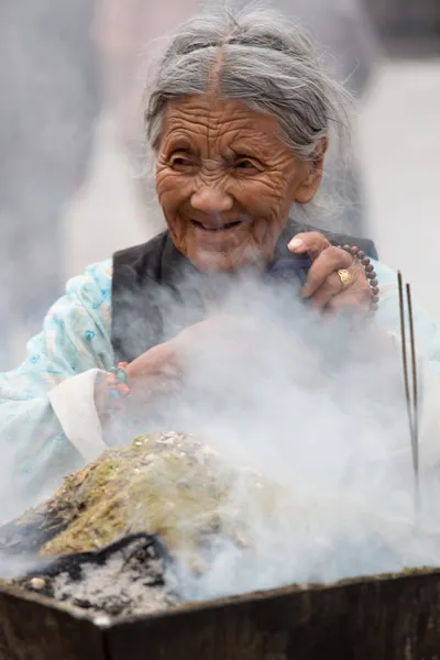 Eldery mulher queimando incenso, Kathmandu — Fotografia de Stock