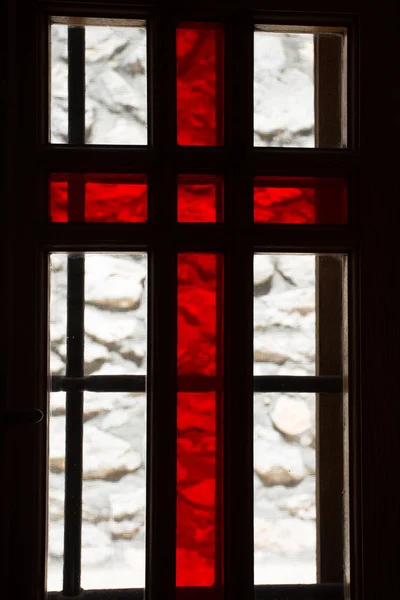 Stained window with red cross in a church — Stock Photo, Image