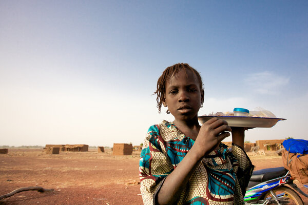 Girl selling food and water on the road to Mopti