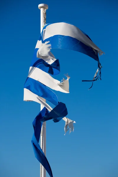 A broken greek flag with a clear blue sky — Stock Photo, Image