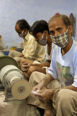 Masked artisans working for Tara, a Fair Trade Organization base clipart