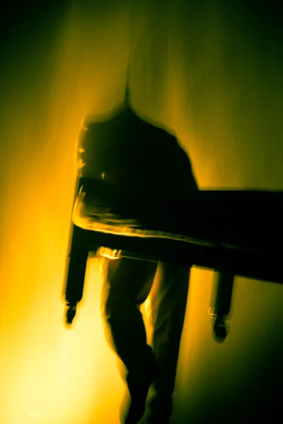 Man running in a haze of yellow water dust — Stock Photo, Image