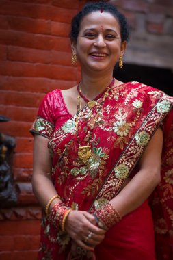Woman dressed in a red traditional indian dress for a wedding in clipart