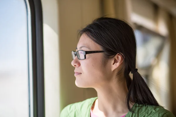 Beautiful woman looking through the window of a Train — Stock Photo, Image