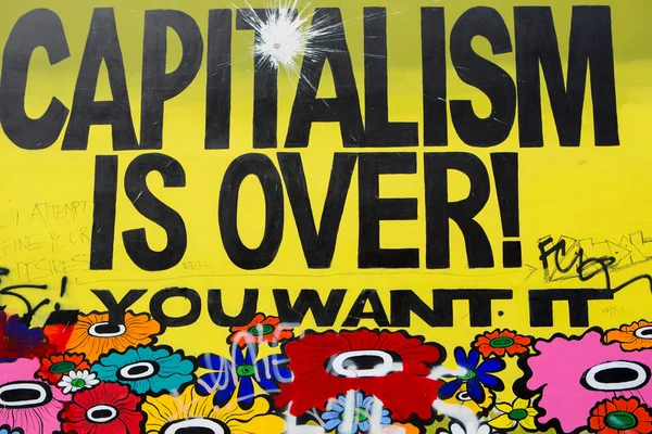 Message on a wall saying capitalism is over, you want it ? — Stock Photo, Image