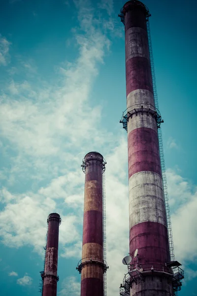 Dramatic sky and three industrial chimneys — Stock Photo, Image