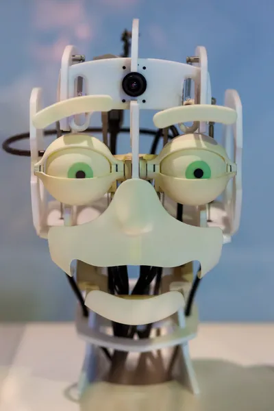 Head of a robot with funny green eyes and a funny expression — Stock Photo, Image