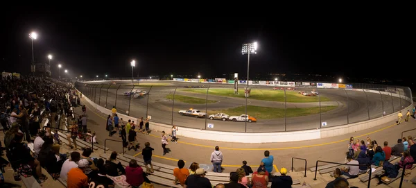 People watchting a stock car competition at night — Stock Photo, Image