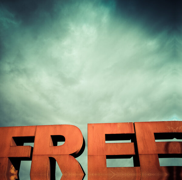 Capital letters FREE with cloudy sky