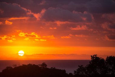 Dramatic sunset sun in clouds on the Pacific clipart