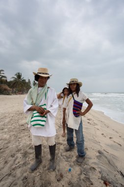 Wayuu familly posing on the beach in Colombia clipart