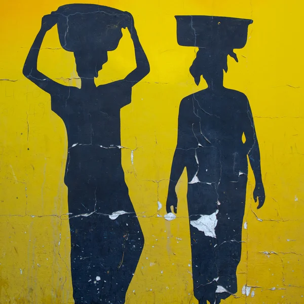 Silhouettes of African women painted on old wall — Stock Photo, Image