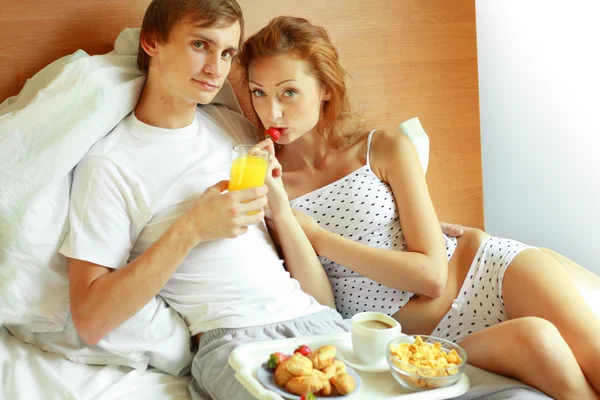 Young couple have breakfast in bed Stock Picture