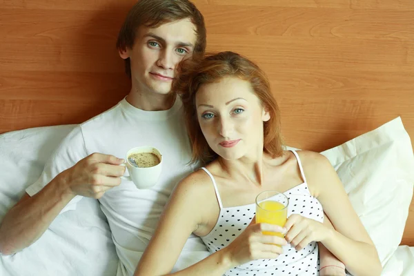 Young couple have breakfast in bed Stock Photo