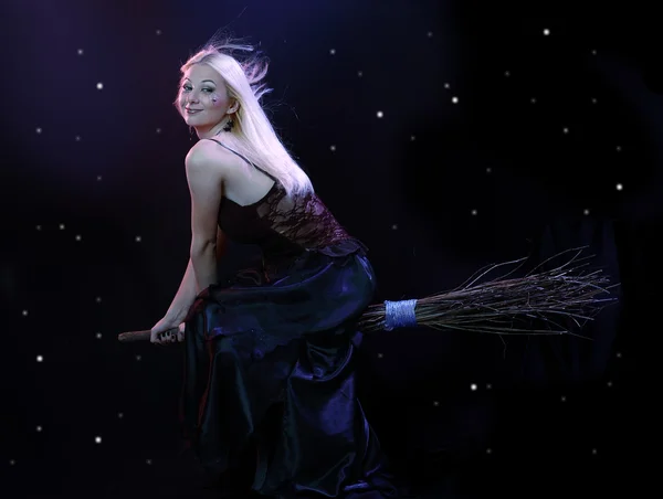 Blond witch flying on broom — Stock Photo, Image