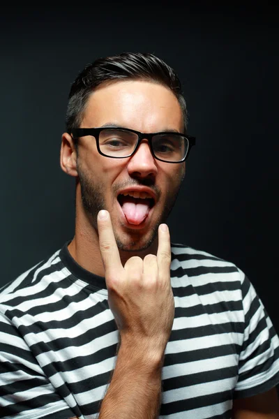 Young man showing his tongue — Stock Photo, Image